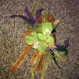 Small orchid corsage with colorful ribbon streamers