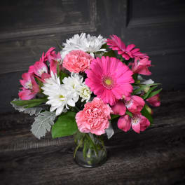 Pink and white mixed bouquet in a clear glass vase
