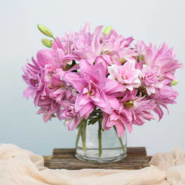 Pink lily bouquet in a clear glass vase