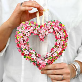 Heart-shaped floral ornament with pink and white blossoms