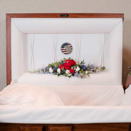 Casket spray with red, white, and blue flowers