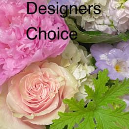 Pastel arrangement of pink peony, blush rose, white hydrangea and greenery in a white vase