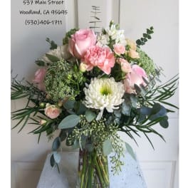 Pink and white bouquet in a clear glass vase