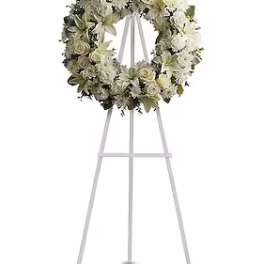 White floral wreath on a standing easel