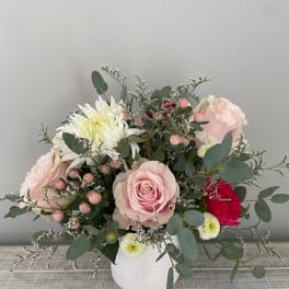 Pink roses and white chrysanthemums in a white vase
