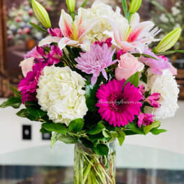Pink and white mixed bouquet in a clear glass vase