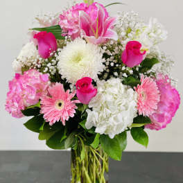 Pink and white mixed flower bouquet in a clear glass vase