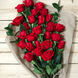 Bouquet of red roses wrapped in brown paper