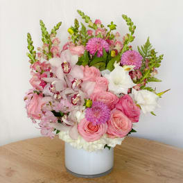Pink and white floral arrangement in a white vase