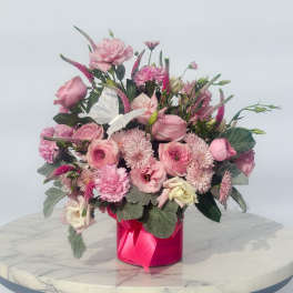 Pink mixed bouquet in a bright pink box with a ribbon