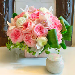 Pink and white rose bouquet with orchids in a square vase