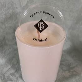 Pink candle in a clear plastic cup with a lid