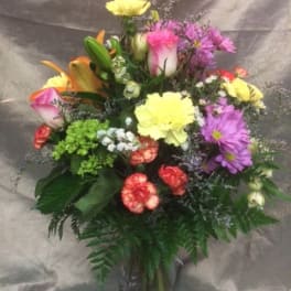 Mixed bouquet of colorful flowers in a glass vase