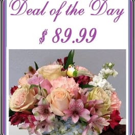 Mixed bouquet of roses, lilies, and hydrangeas in a vase