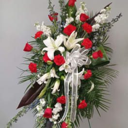 Red and white floral standing spray with lilies and roses