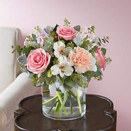 Pink and white bouquet in a clear glass vase