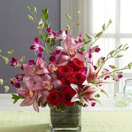 Pink lilies and red roses in a glass vase