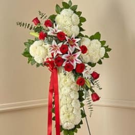 Standing floral spray with red roses, white blooms, and a red ribbon