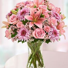 Pink mixed flower bouquet in a clear glass vase