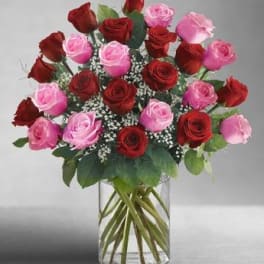 Bouquet of red and pink roses in a clear glass vase