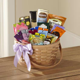 Basket of assorted tea and snack packages with a lavender ribbon