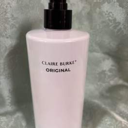 Pink body lotion bottle with a black pump dispenser