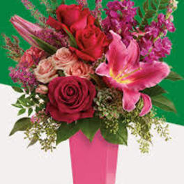 Pink and red floral arrangement in a pink vase