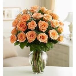 Peach roses arranged in a clear glass vase