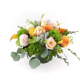 Mixed bouquet of peach, orange, and white flowers in a vase