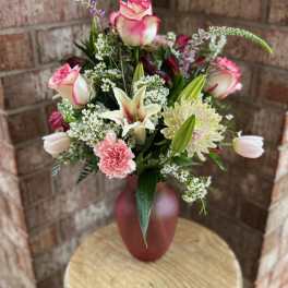Pink and white bouquet in a red vase