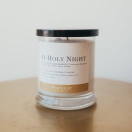 Glass jar candle with a black lid and labeled "O Holy Night"