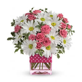 Pink roses and white daisies in a pink square vase