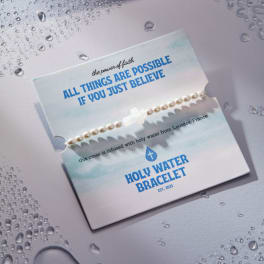 Pearl bracelet on a printed card with blue text