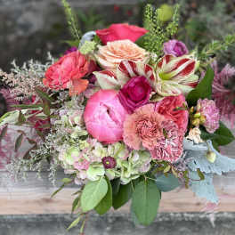 Mixed bouquet of pink and peach flowers with striped blooms