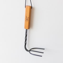 Handheld garden cultivator with a wooden handle on a white background