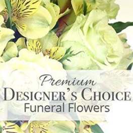 Soft yellow and cream flowers with a Premium Designer's Choice Funeral Flowers text overlay