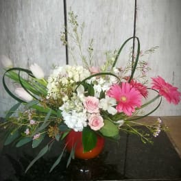 Pink gerberas and roses in a red vase with white tulips
