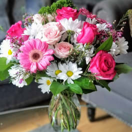 Pink and white mixed flower bouquet in a glass vase