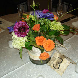 Colorful floral centerpiece in a glass vase on a table