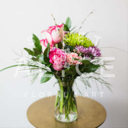 Pink and purple mixed bouquet in a clear glass vase