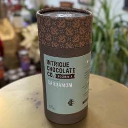 Cardboard canister of cardamom cocoa mix on a table