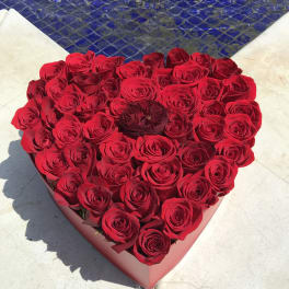 Heart-shaped box filled with red roses