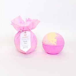 Pink wrapped gift set with a round bath bomb and a thank-you tag