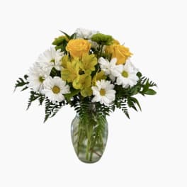 Yellow roses and white daisies in a glass vase