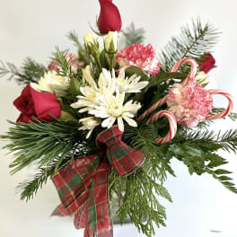Holiday bouquet with red roses, white daisies, and candy canes