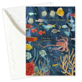 Greeting card with colorful fish and an octopus on a dark blue background
