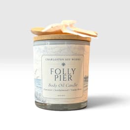 Body oil candle in a glass jar with a wooden lid and ribbon