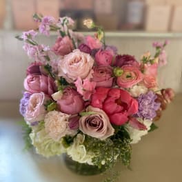 Pink and lavender bouquet of mixed flowers in a glass vase