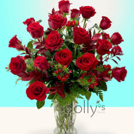 Red roses arranged in a clear glass vase