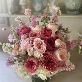 Pink and cream rose bouquet in a glass vase